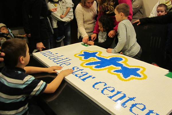 Learners help finish placing LEGOS® on the mosaic. Learners help finish placing LEGOS® on the mosaic.